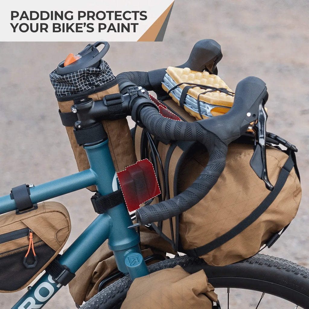 Bicycle with brown saddlebags and padding on a blurred road background