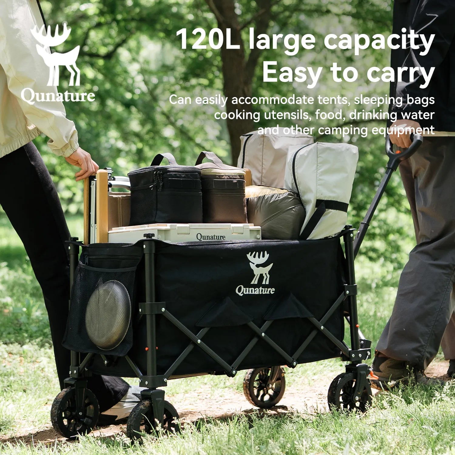 Two people are pulling a 120L utility wagont filled with camping supplies outdoors
