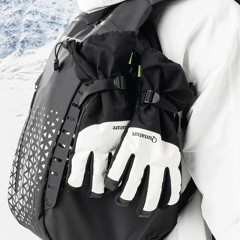Person wearing black gloves and a backpack with a scenic background